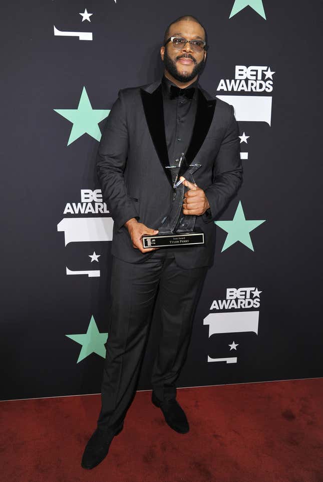 Tyler Perry poses in the press room with the Ultimate Icon Award at the BET Awards at the Microsoft Theater in Los Angeles.